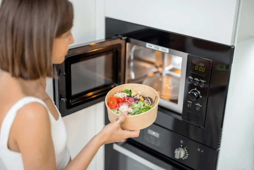 woman-heating-food-with-microwave-machine